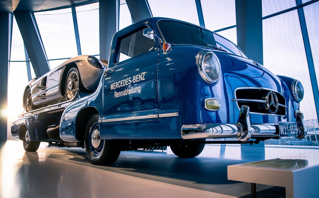 digital Vintage Mercedes-Benz racing truck displayed indoors in a modern showroom setting.