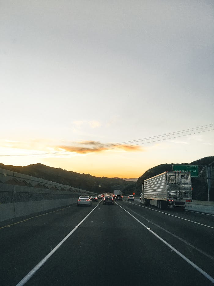 Services-01 Traffic flows smoothly on a Los Angeles highway at sunset, showcasing the serene landscape.