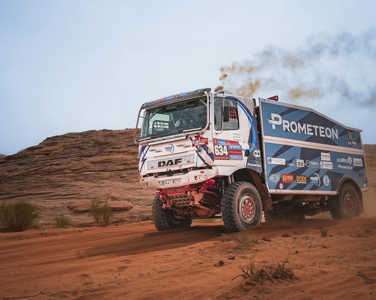creative-03 A rugged off-road racing truck powers through a desert terrain, showcasing speed and endurance.
